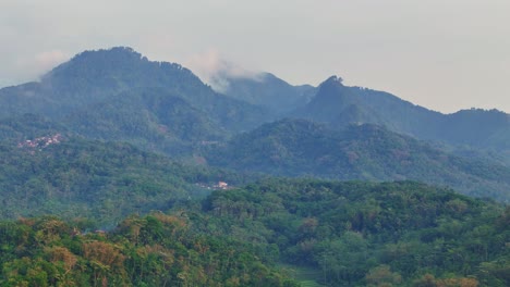 landscape of forested hills on a very cloudy and foggy day. hills on indonesia.