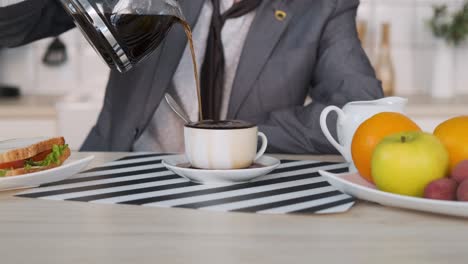 cinemagraph de un hombre de negocios vertiendo café en casa