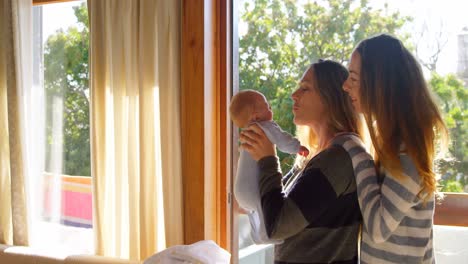 Lesbian-couple-holding-their-baby-boy-4k