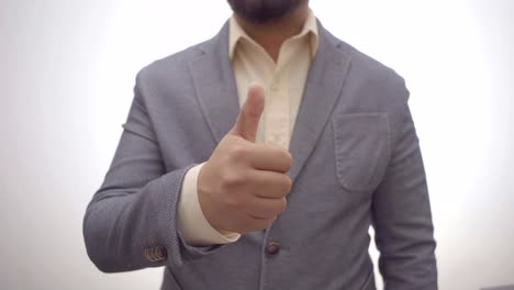 a businessman showing thumbs up