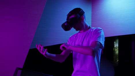 man with a vr headset making various hand movements in the air, medium shot