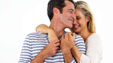 Happy-young-couple-embracing-each-other-against-white-background