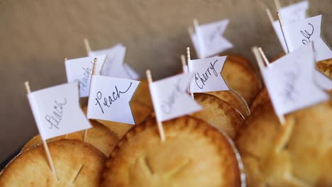 Slow-Motion-Shot-of-a-small-box-of-different-flavored-miniature-pies