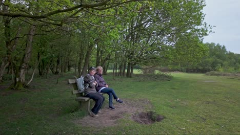 female walking friends sit enjoying companionship among peaceful nature