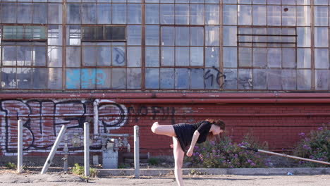 woman does interpretative dancing, urban industrial abandoned building, barefoot