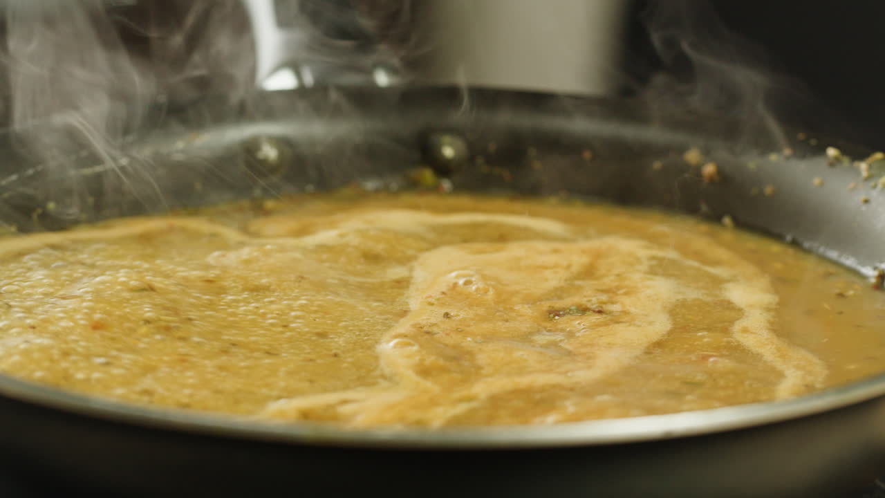 Cooking traditional Indian meal Palak Panir with spinach and cheese close up. Palak paneer is an Indian dish, consisting of paneer in a thick paste made from pureed spinach, Palak paneer is prepared by first boiling and pureeing spinach.