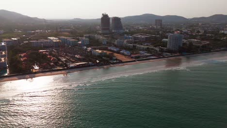 sunset aerial view of hua hin beach drone fly above waterfront hotel building on tropical ocean sea travel holiday destination near bangkok