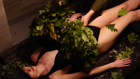 woman receiving a banya treatment