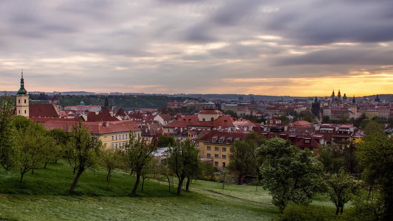 Sunrise timelapse of Prague, Czech Republic as seen from the orchards of Petrin gardens with a view of the St