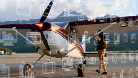 business and travel icons animation over small aircraft and person on runway