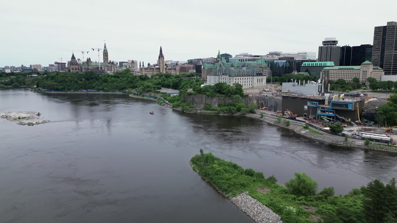 City of Ottawa on a river with Parliament buildings supreme court of Canada downtown. Tracking in aerial shot
