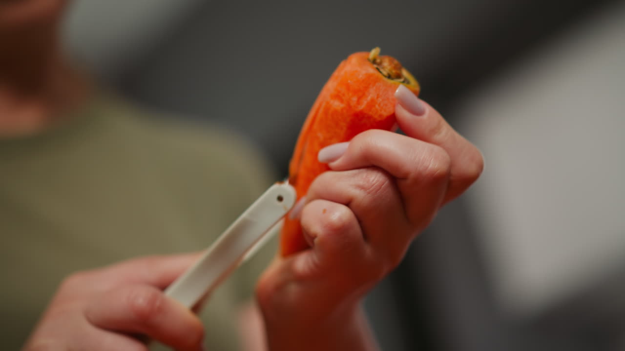 Woman peeling a carrot