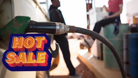 Animation-of-hot-sale-text-over-diverse-man-and-woman-filling-truck-with-fuel-pump-at-petrol-station