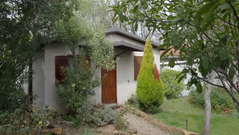 countryside house among green trees and bushes