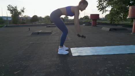 fit woman does burpees in a tracking shot