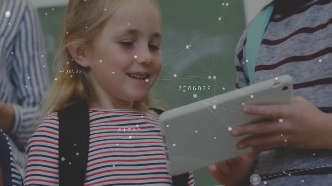 Two girls using tablets in classroom, camera focusing on girl tapping screen and sharing discovery