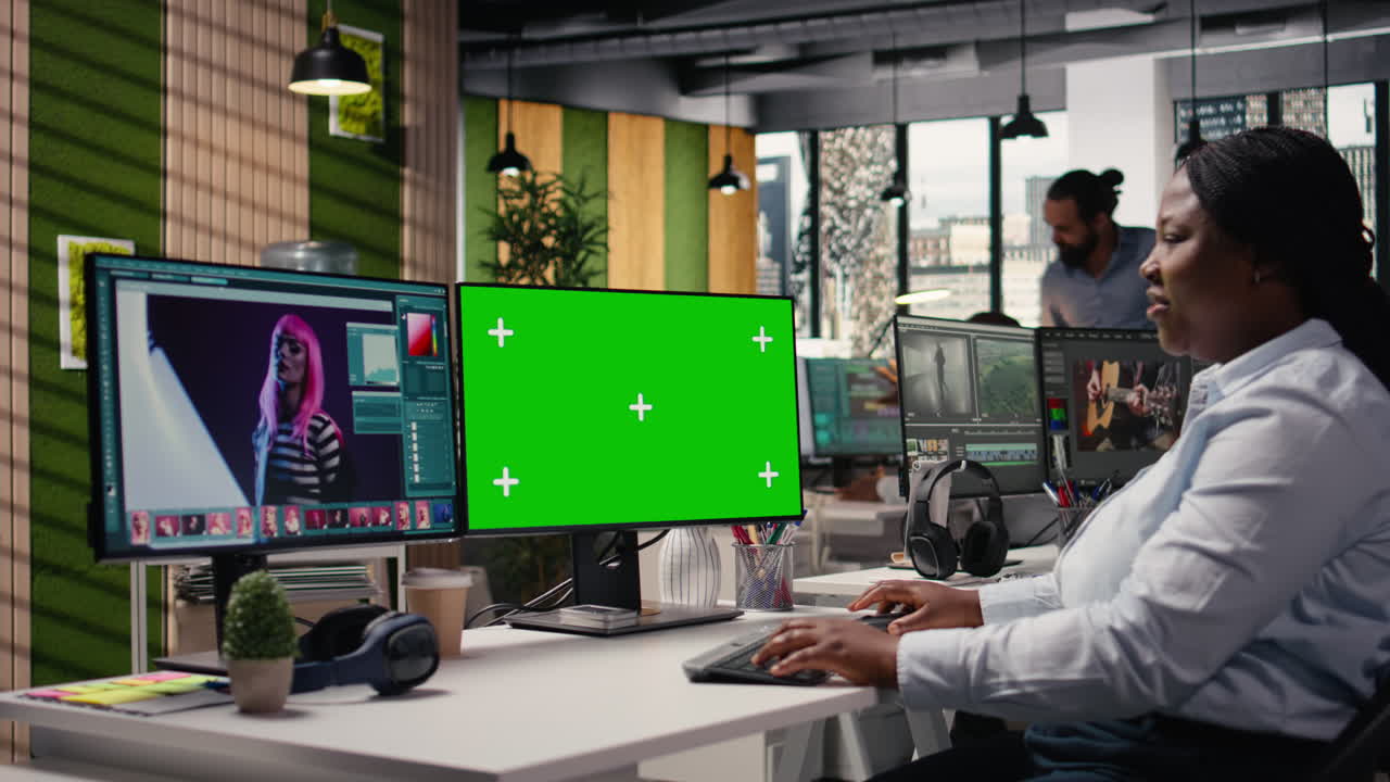 Green screen monitor next to editing software for commercial catalog photos