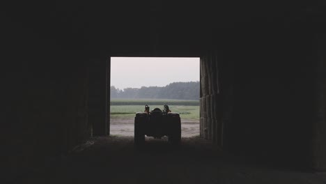 artistic shot of tractor in shadow and light inside a barn