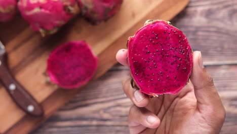 dragon fruit slice held in hand