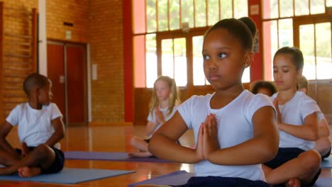 schoolkids performing yoga on a exercise mat in school 4k