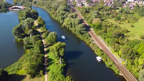 aerial-shot-of-a-yacht-sailing-in-a-canal-during-the-day-in-Norwich,-England