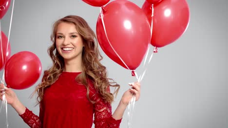 Woman-dancing-among-red-balloons