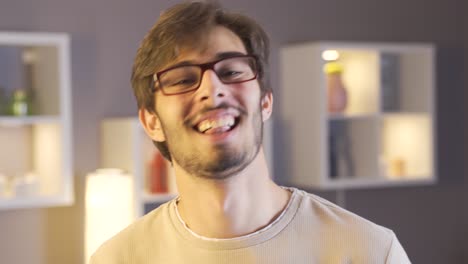 young man dancing and singing at home.