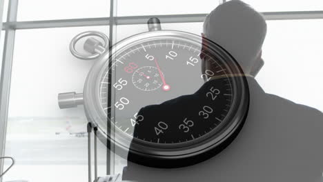 silhouette of person at airport window with stopwatch animation overlaying view