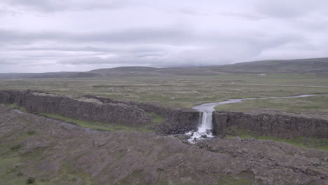 öxarárfoss waterfall in iceland aerial push in over landscape