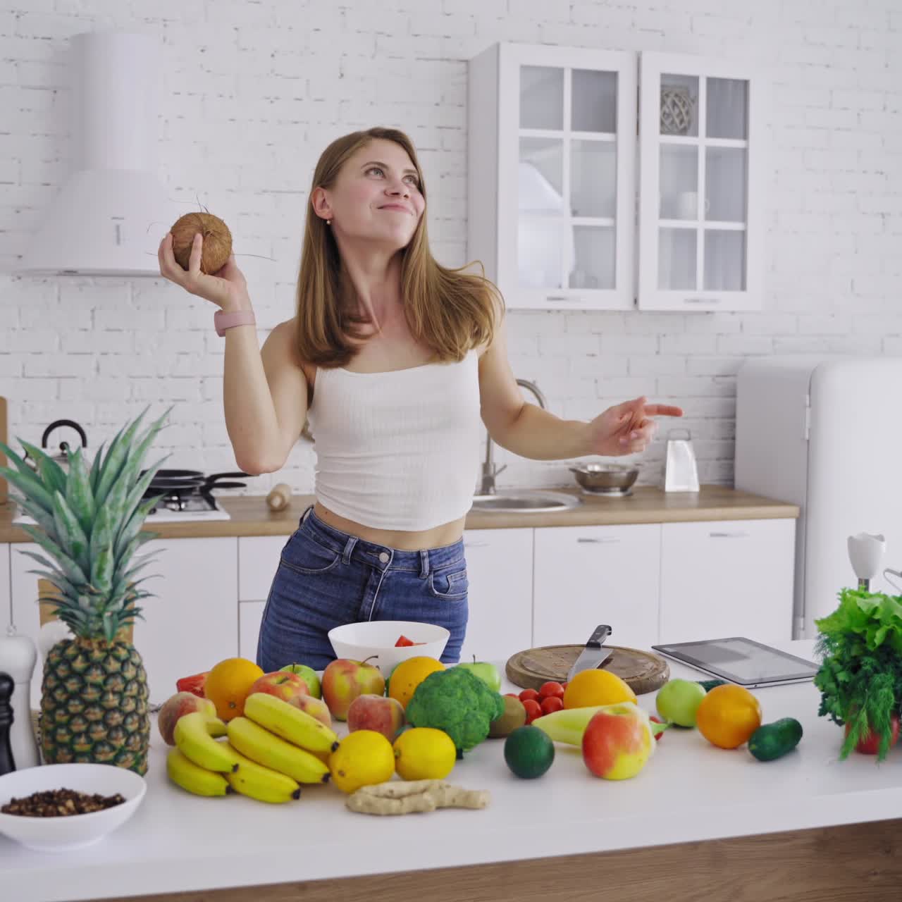 Woman with coconut in kitchen