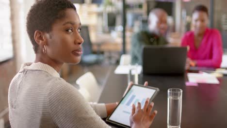 Portrait-of-happy-african-american-colleagues-with-laptop-discussing-work-in-office,-slow-motion