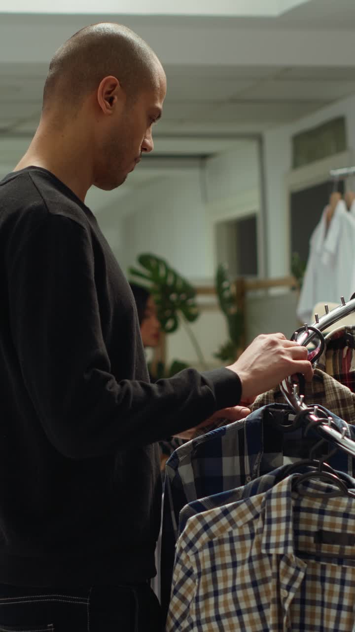 Man shopping for shirts in a clothing store