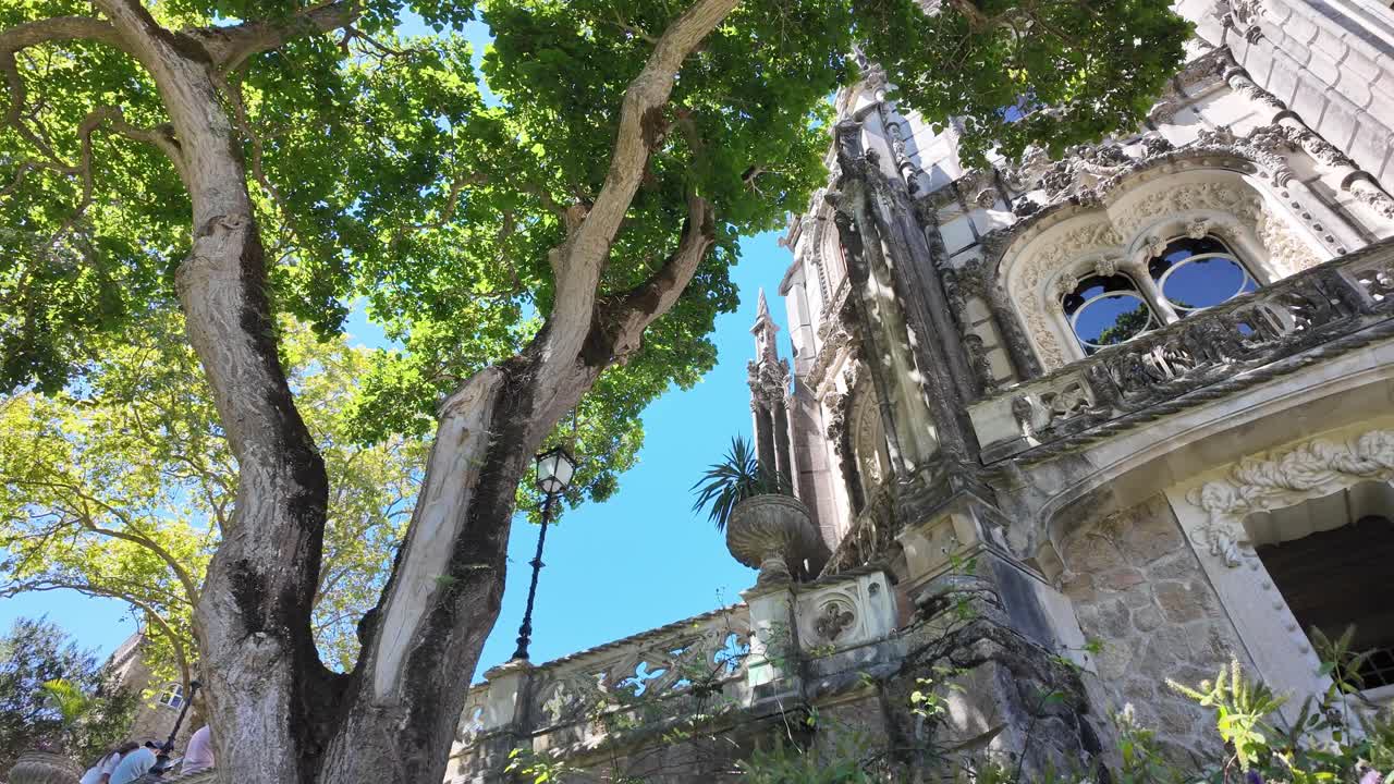 Quinta da regaleira gardens with tourists walking in sintra, portugal, aerial view
