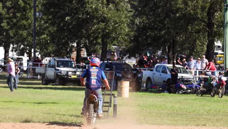 motorcyclist performing stunts in front of spectators