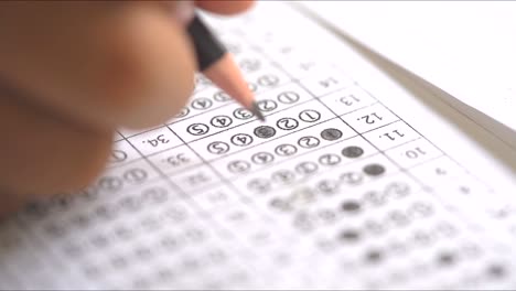 test exam concept, pencil writing answer on paper answer of question in examination test.