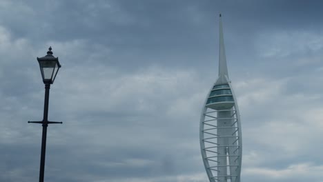 The-Spinnaker-Tower-in-Portsmouth,-next-to-a-Victoria-lamppost-on-a-cloudy-day