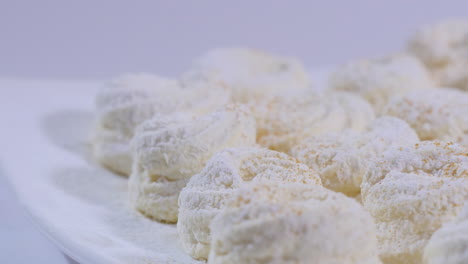 white powdered sugar cookies on a plate