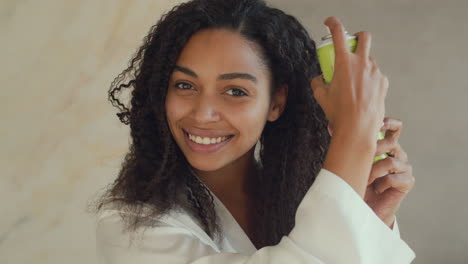woman applying hair spray