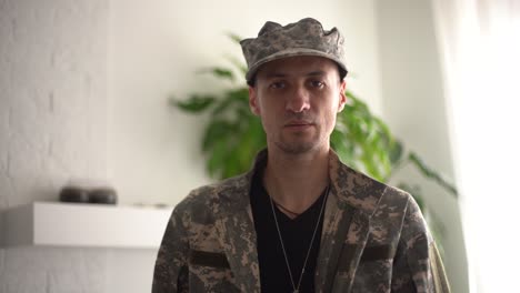 Serious-responsible-young-guy-looking-at-camera-listening-order-with-confidence,-discipline.-Indoor-studio-shot