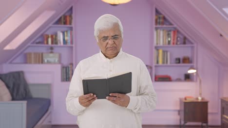 Indian-old-man-reading-a-book