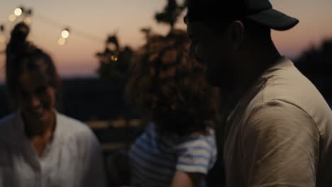 group of friends dancing at the party in top of the roof.