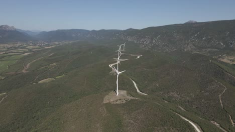 Single-line-of-wind-turbines-in-lush-green-foothills-valley-in-France