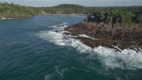 Establishing-Aerial-Drone-Shot-Revealing-Hiriketiya-Bay-behind-Headland-in-Southern-Sri-Lanka