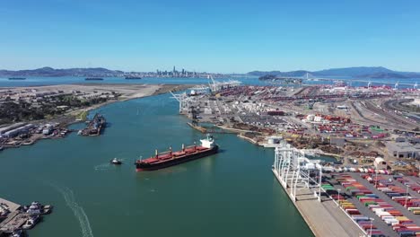 container ship being turned around by tug boats on the oakland inner bay