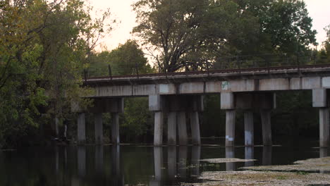 static shot of an old train bridge on the san marcos river on a long lens