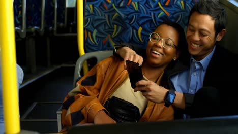 couple taking selfie on mobile phone while travelling in bus 4k