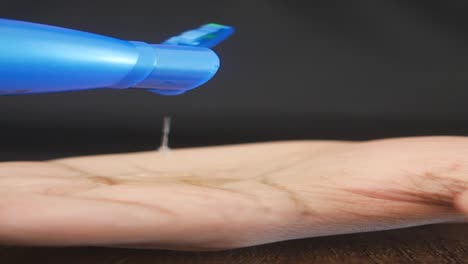 close-up of a hand with coconut oil being poured on it