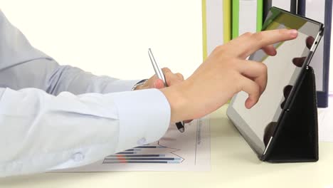 businessman using tablet and reviewing data charts