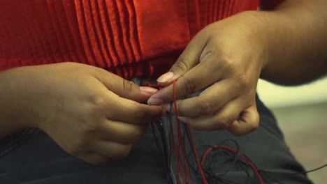 handheld shot of an indigenous woman doing her artcrafts in mexico