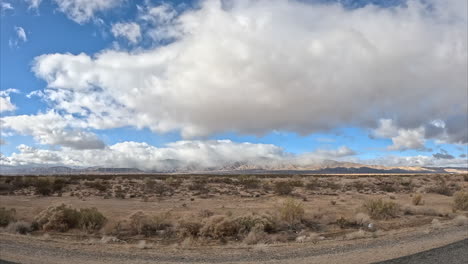 driving through the mojave desert's vast landscape while looking out the passenger window